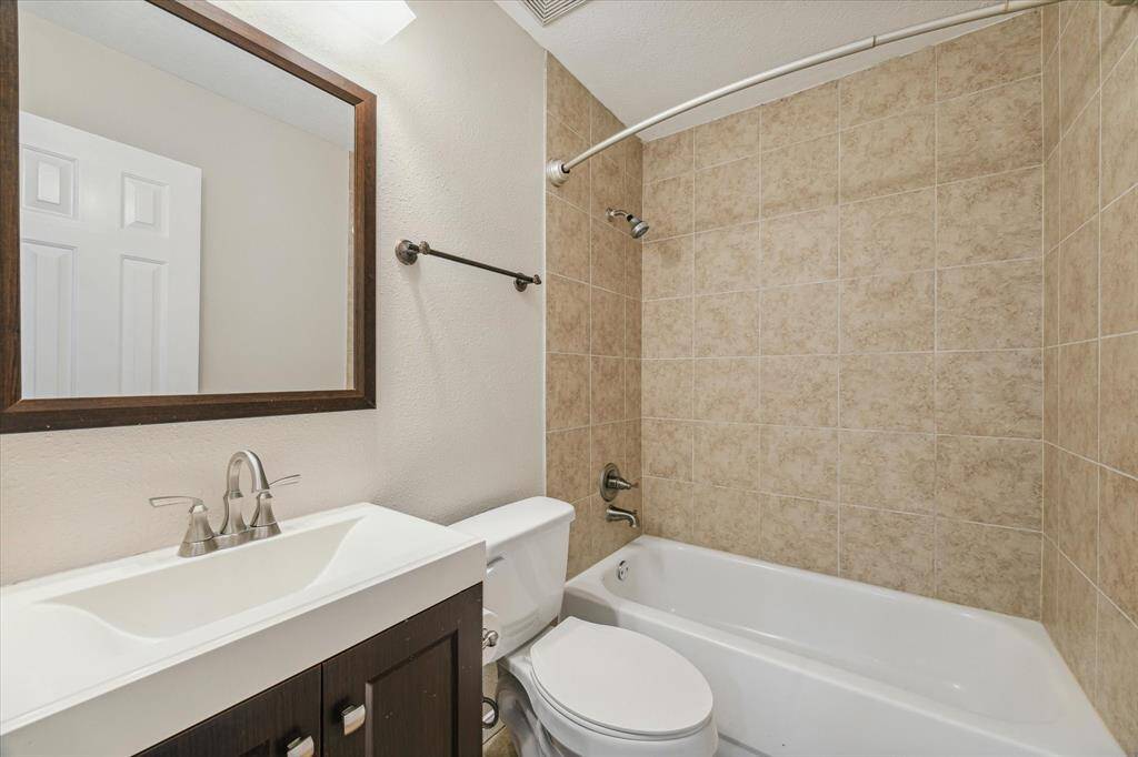 This secondary bathroom has a tub/shower combo and was recently repainted.