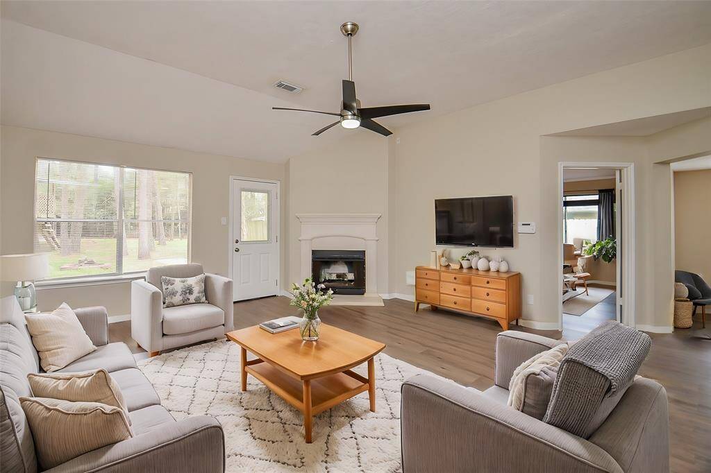 On cooler fall and winter days, the gas log fireplace will be a welcome feature, adding warmth and ambiance. The stone surround and mantel enhance the charm of the room, and the double windows offer a lovely view of the wooded backyard.
