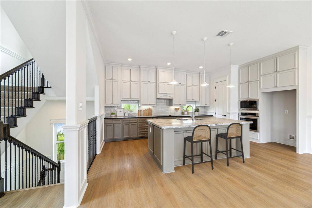 This well-appointed kitchen has modern, elegant finishes and lots of room to gather! (digitally-staged)