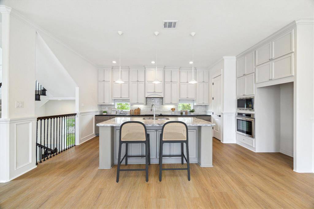 The huge kitchen island is open to the living room. This space is perfect for entertaining!(digitally-staged)