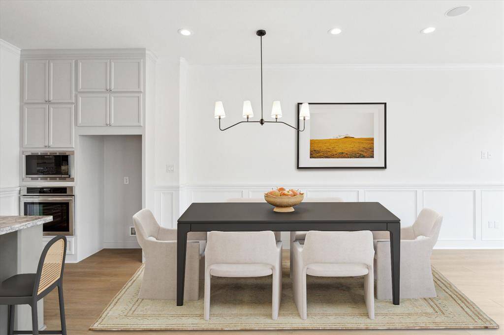 A new lighting fixture marks the dining area - a great spot to share a meal! (digitally-staged)