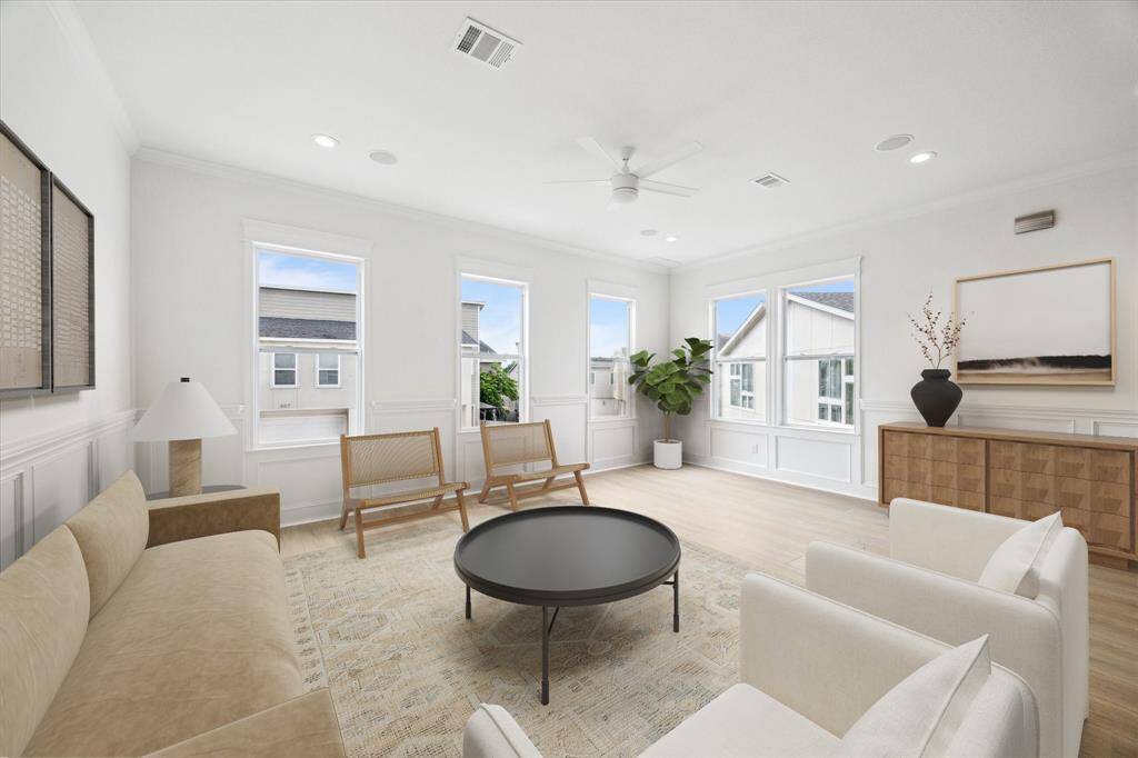 Gather together in the large living room.  Large windows and new lighting keep it bright! (digitally-staged)