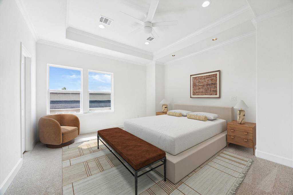 The primary suite has high ceilings and a large ensuite. (digitally-staged)