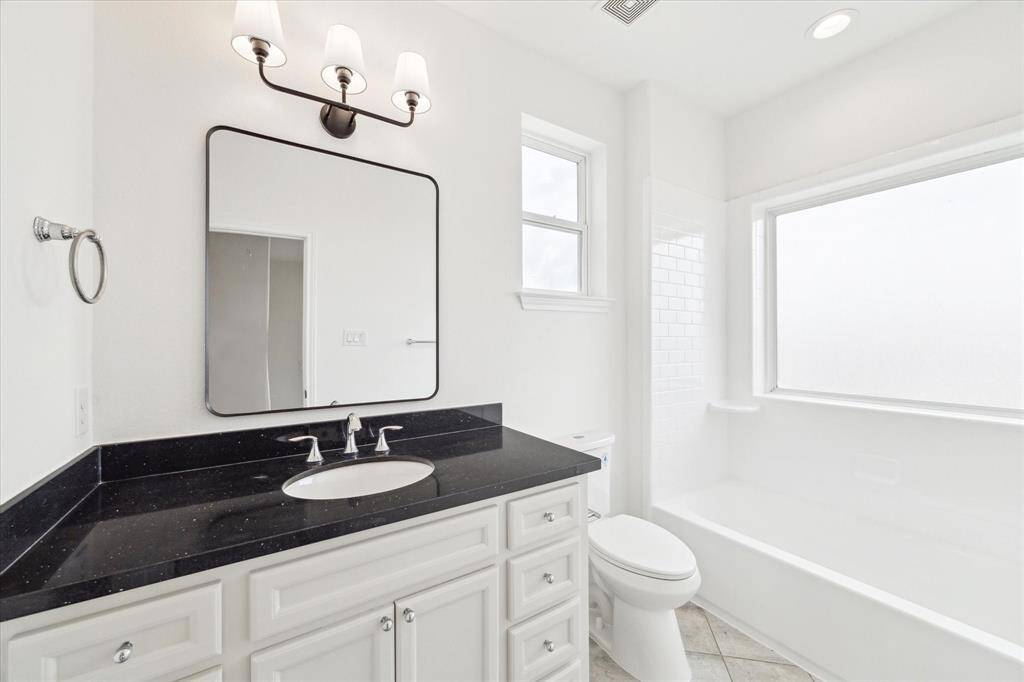 The hall bath upstairs is in great condition with beautiful vanity and stylish fixtures.