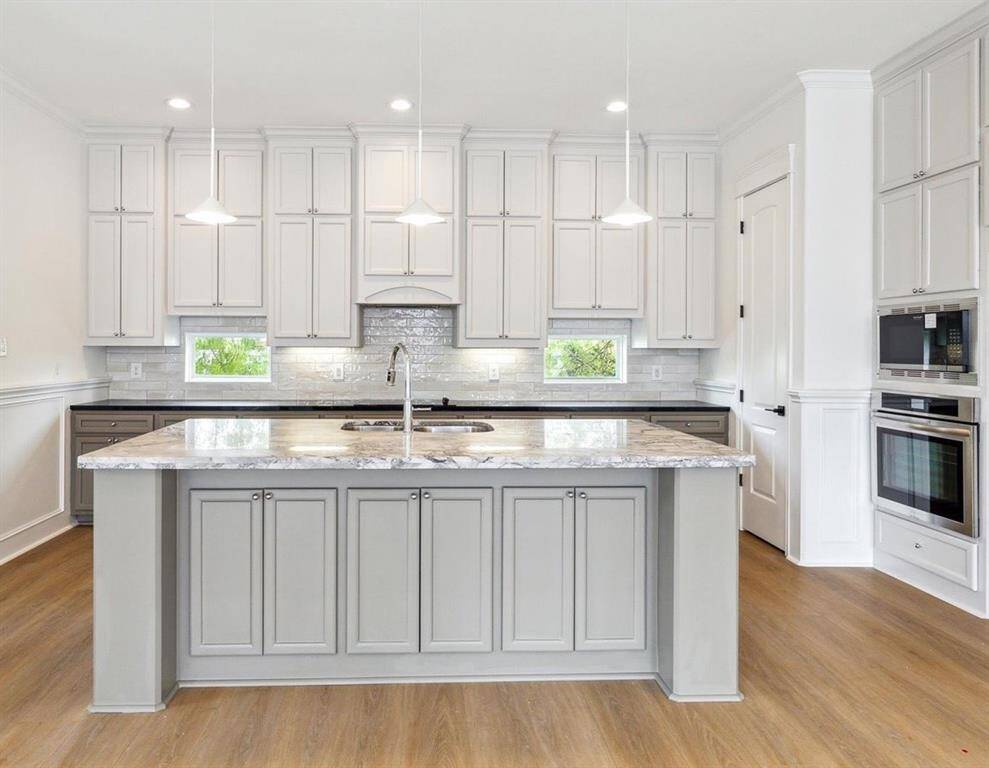 The open-concept layout features a beautiful kitchen with huge island.