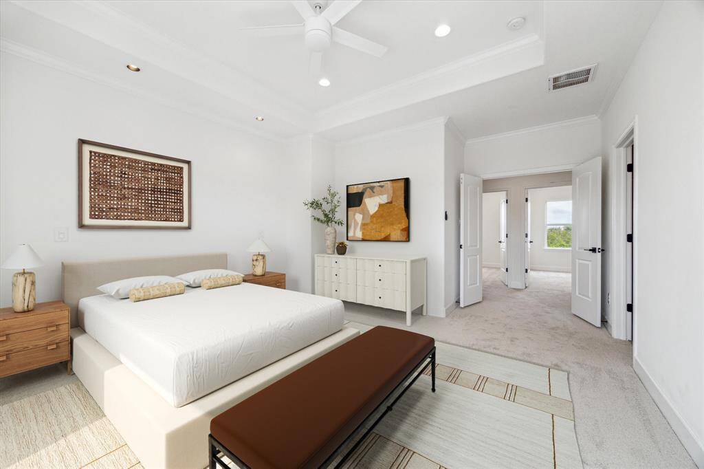The spacious primary suite offers every convenience. (digitally-staged)