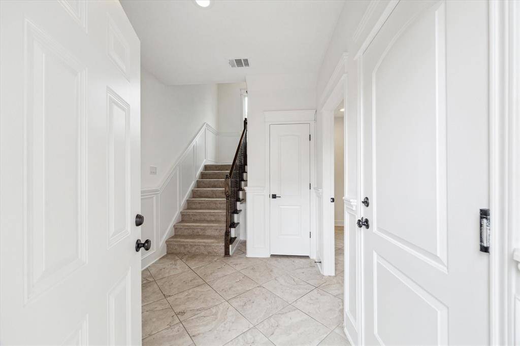 Come on in!  The ground floor provides a large garage and secondary bedroom and additional storage options.