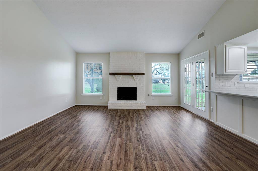 Just off of the living room is a double-door exit to the back patio. The windows bring in a ton of natural light to the space.