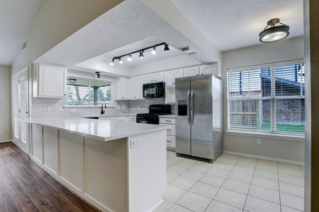 The kitchen was remodeled in 2/24 with white painted cabinets, quartz countertops with extra long breakfast bar, accented backsplash, sink and faucet, and refrigerator.