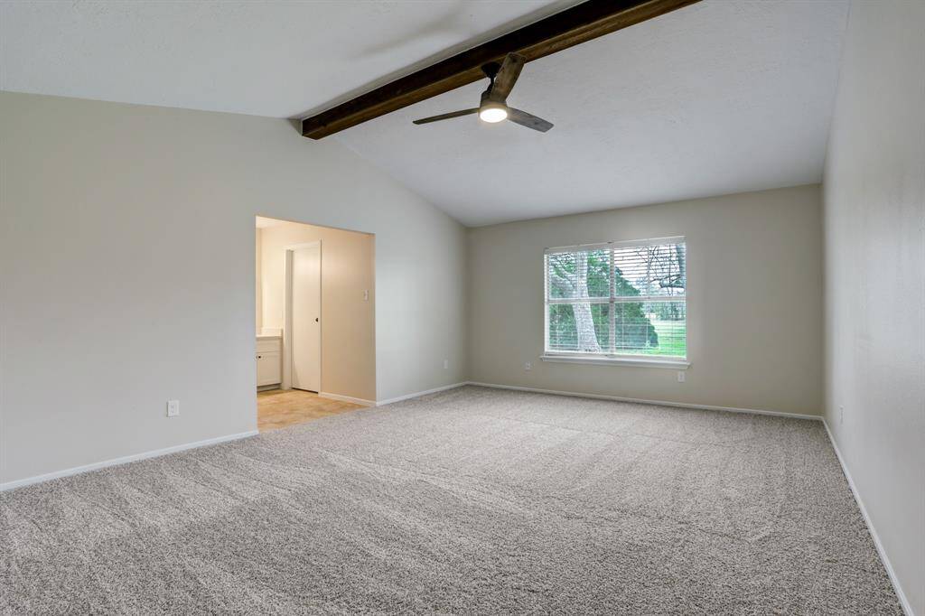 The primary bedroom is massive and features a re-stained wood beam in the vaulted ceiling.  Shampooed carpet, en-suite bathroom, and a large window with a view of the backyard allows for this to become your new private sanctuary.