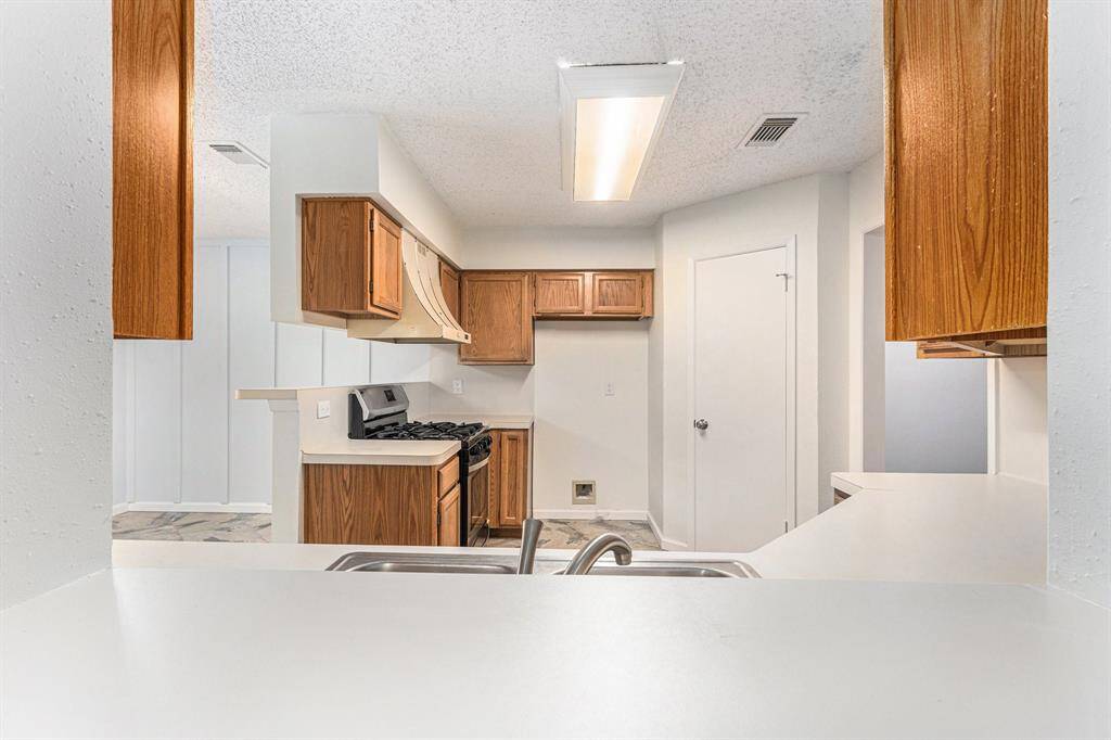 View from Den into kitchen with handy 2nd breakfast bar