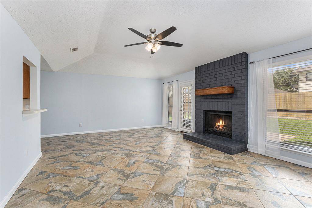Another view of Den. Cozy floor to ceiling all brick wood burning fireplace