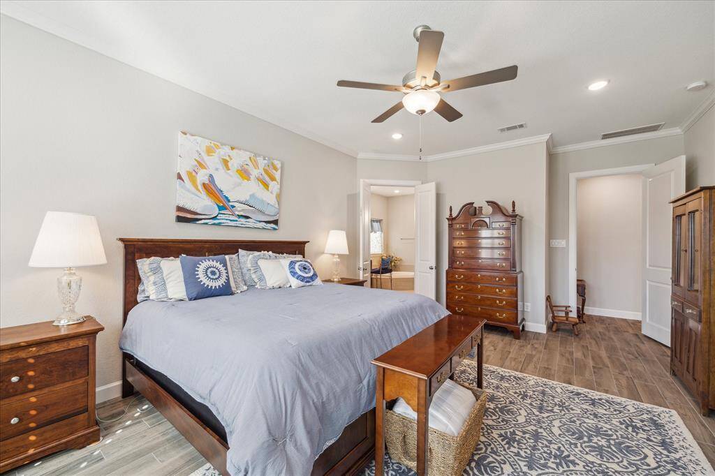 Another view of the spacious primary bedroom, highlighting its elegant design and private access to the ensuite bathroom.