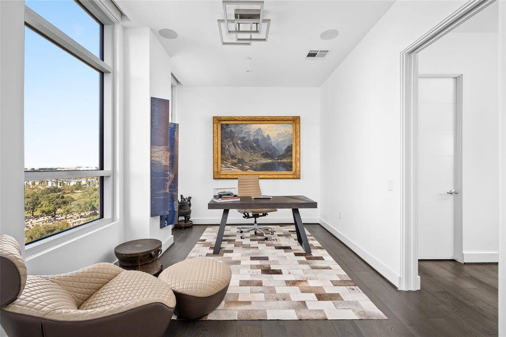Located just off the primary bedroom, the study features elegant hardwood floors, an ET2 Traverse flush-mount light fixture, integrated Savant surround sound, and expansive windows that offer stunning views, creating an inspiring and serene workspace.