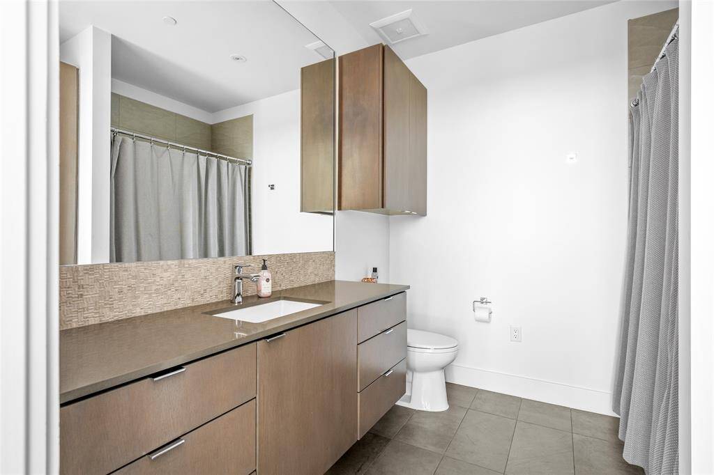 With every bedroom in the home enjoying the privacy of its own ensuite bath, this bathroom offers modern elegance and is designed with sleek Silestone counters and Hansgrohe plumbing fixtures.