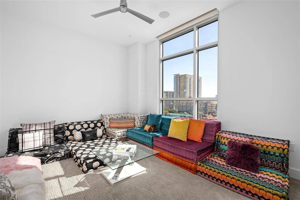 Currently used as a movie room, this secondary bedroom features window coverings and integrated Savant surround sound, offering a versatile space with modern conveniences.