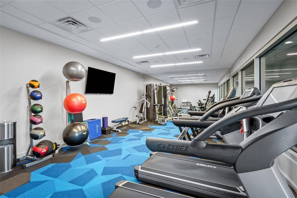 The building's state-of-the-art gym is designed to cater to all fitness levels and features a variety of high-quality equipment. With a sleek, modern aesthetic and ample space, this fitness center provides residents with the convenience of maintaining an active lifestyle just steps from their door.