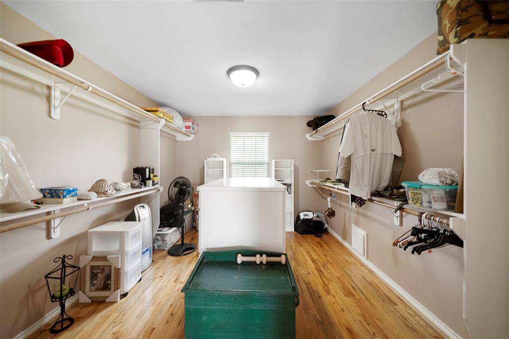 A true walk-in dream! Plenty of built-in storage and hanging space with room to organize and expand.