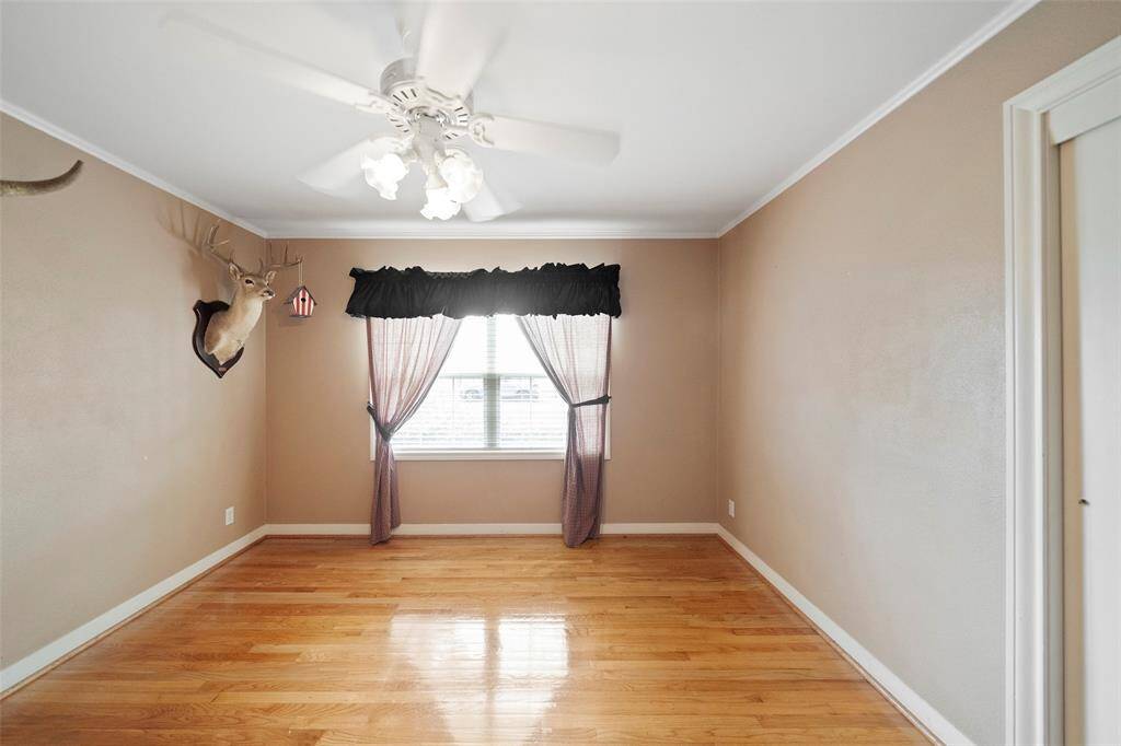 A cozy room with wood flooring and natural light—great as a guest bedroom, office, or creative flex space.