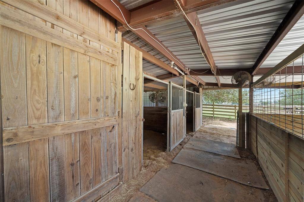 Sturdy wood and metal stalls with attached fans offer a comfortable space. Personal-use only—no commercial boarding permitted.
