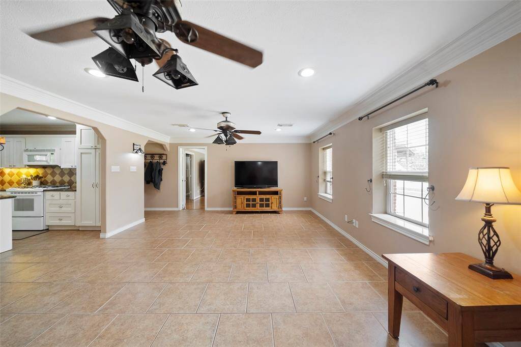 Large windows bring in great natural light, while tile flooring throughout offers durability and easy upkeep for everyday living.