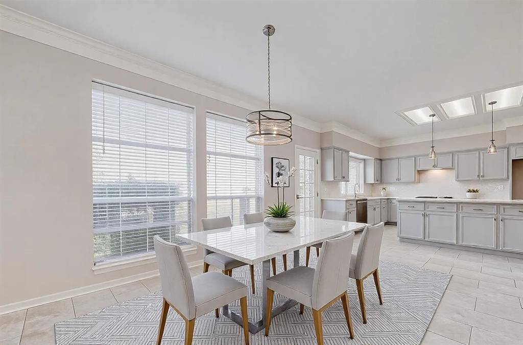 VIRTUALLY STAGED TO SHOW THAT YOU CAN HAVE AN OVERSIZED DINING TABLE IN THE BREAKFAST AREA