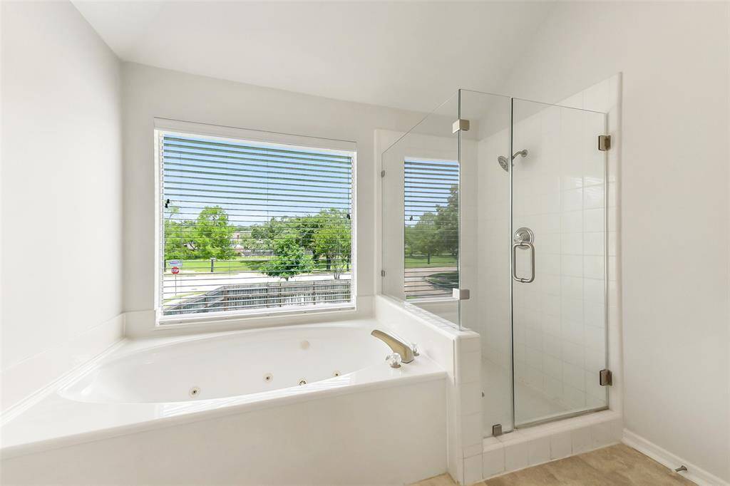 OVER-SIZED PRIMARY BEDROOM FEATURES CROWN MOLDING, VAULTED CEILING, AND CEILING FAN. PLENTY OF ROOM FOR WORKOUT EQUIPMENT, DESK SPACE, OR SITTING AREA