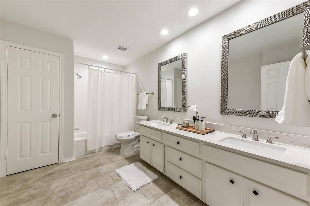 SPACIOUS PRIMARY BATHROOM WITH OVERSIZED SHOWER, LARGE TUB, AND DUAL SINKS.