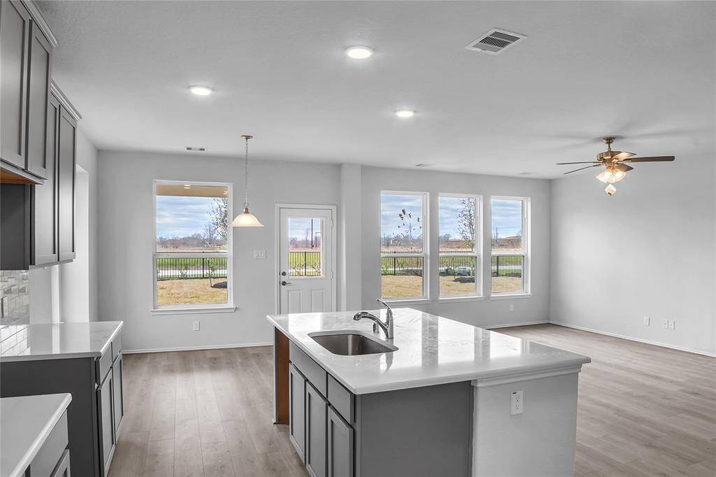 The Princeton- Kitchen into the Family Room- Home under construction. Sample floor plan photo used for illustrative purposes only. Upgrades, selections options, windows and colors may vary.