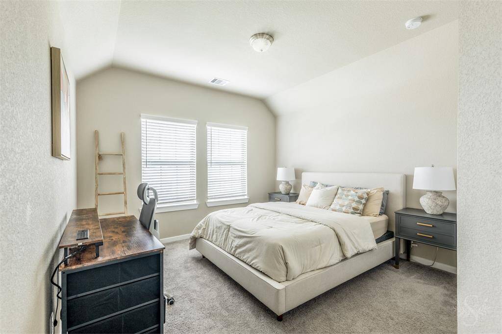 Secondary bedroom providing the space you need for a large bed and any additional furnishings needed including student desks and bookcases. Featuring a high angled ceiling, plush carpet for comfort and a walk-in closet.