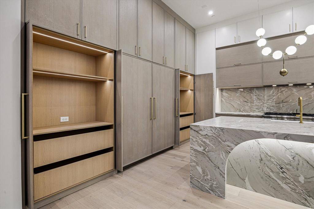 Two large storage units with shelves and drawers have retractable door to hide them away while entertaining.