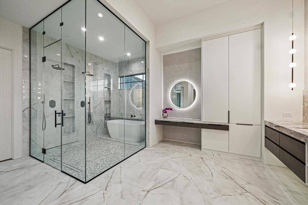The curbless glass soaking tub and shower enclosure is immense.