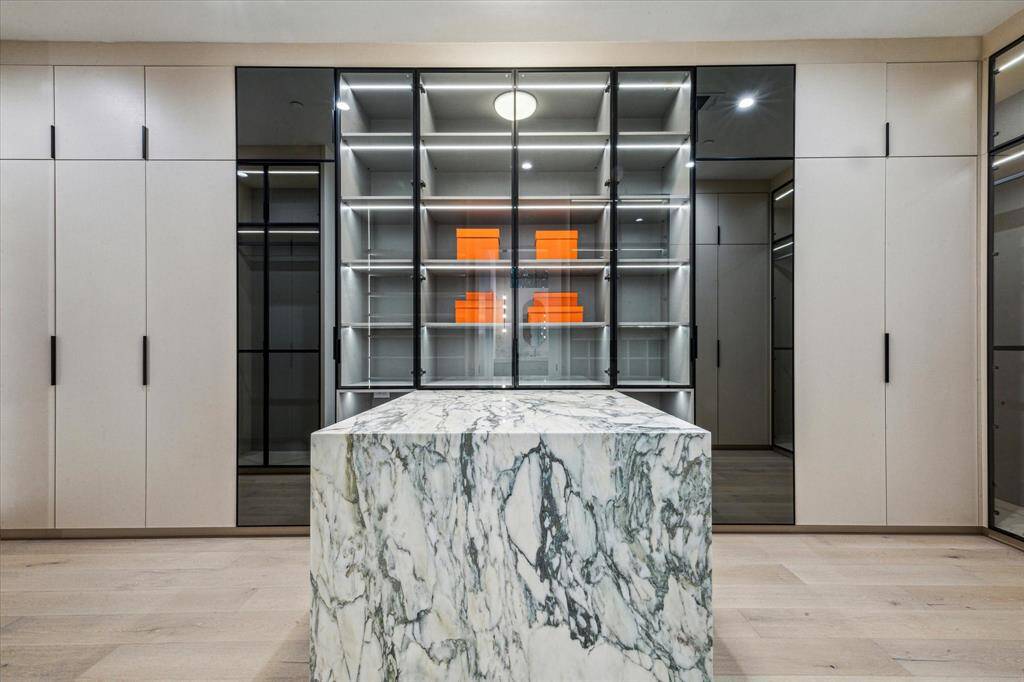 Calcutta Gold marble is used in the Primary closet island.