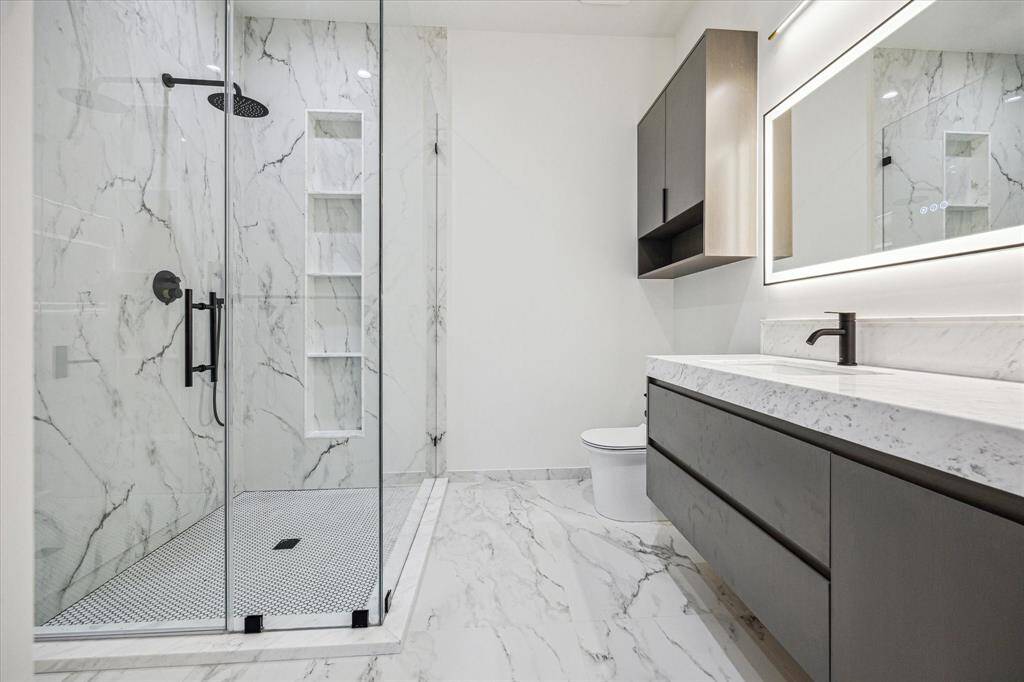 The secondary baths all have Calcutta Gold counter tops.