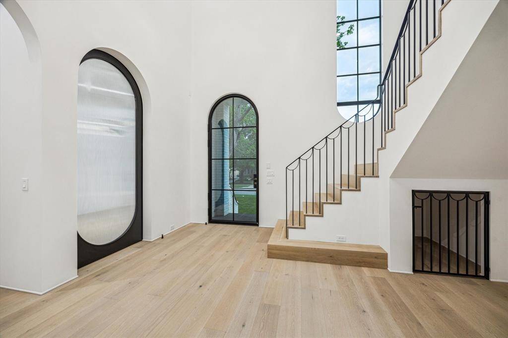 The first floor Study is hidden from view by a tall custom made roll away metal door with a translucent reed glass insert.