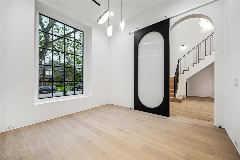 The massive rolling door is seen here in its open position when it is completely invisible from the Entry. All windows are RAM insulated aluminum,  either casement or fixed pane.