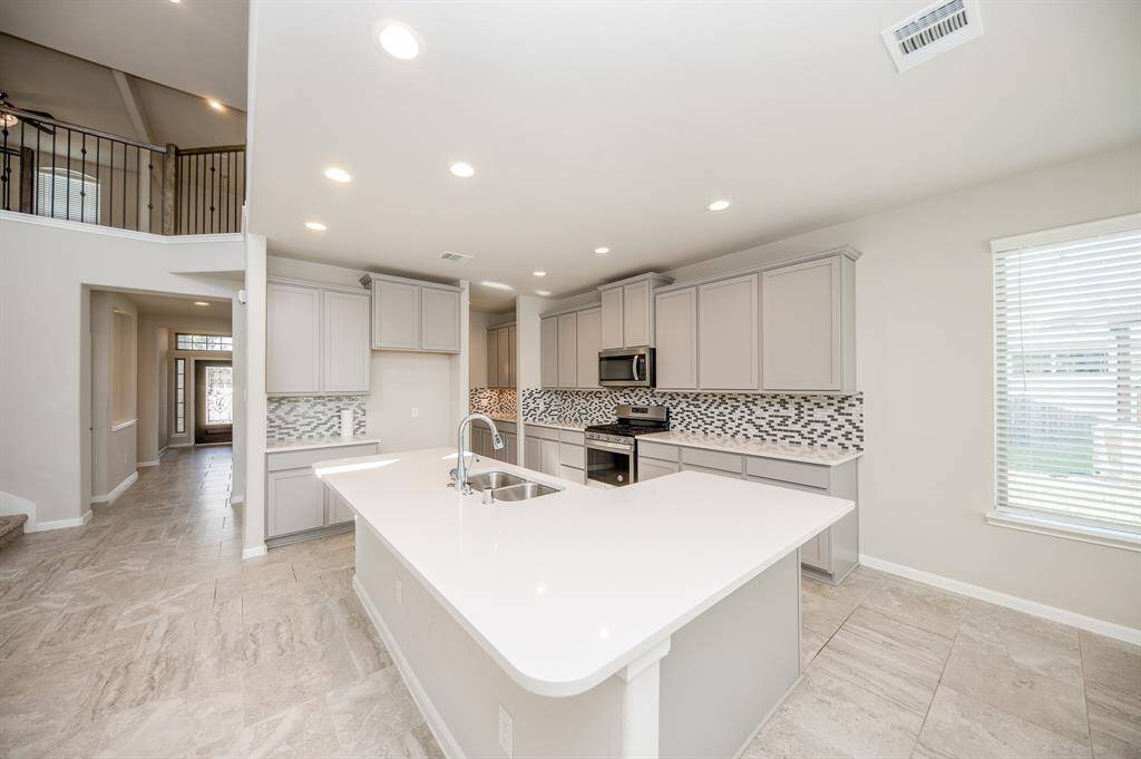 Here is another view of the kitchen, notice the beautiful quartz countertops.