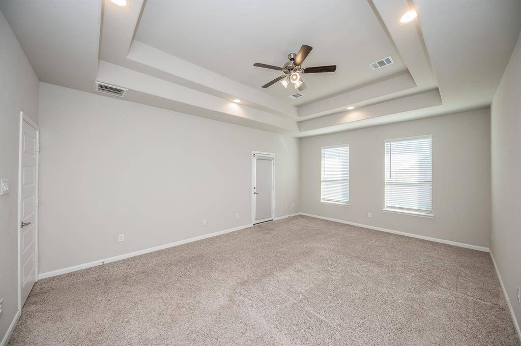 Notice the beautiful double tray ceiling. This space is perfect for a King sized bedroom set.