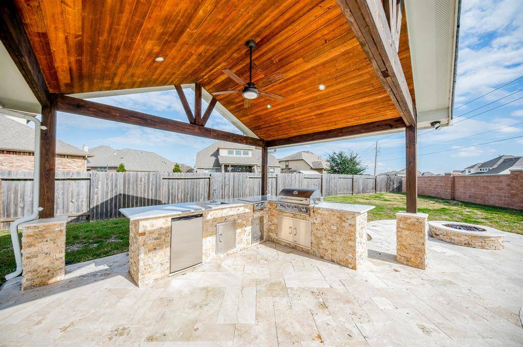 The home not only comes with a covered patio, but a secondary covered kitchen area.
