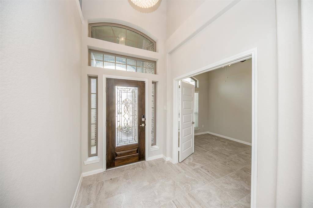 This foyer boasts a beautiful chandelier. You will have to take in the full view of the chandelier in person.