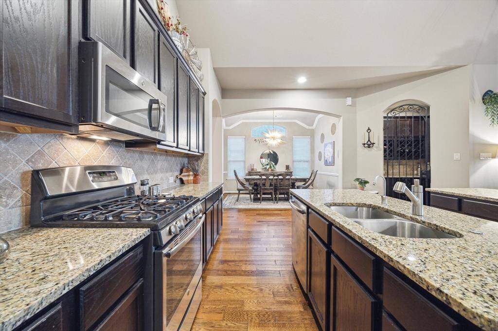 This gourmet kitchen boasts gorgeous granite countertops, rich cabinetry and  stainless steel appliances.