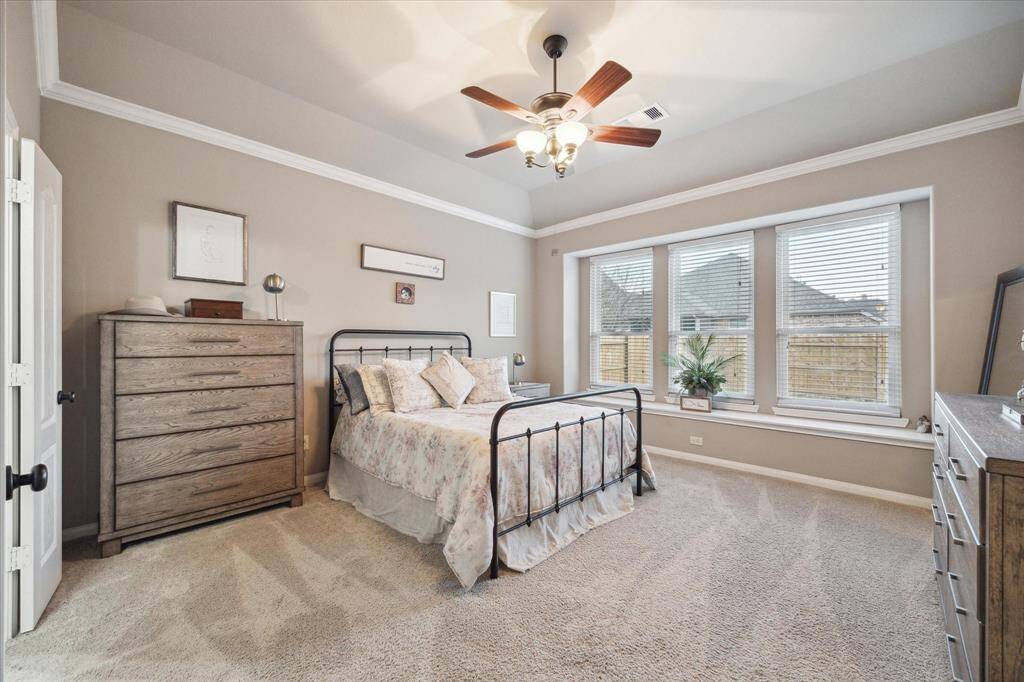 Imagine starting your day with the gentle warmth of sunshine streaming through large windows, filling your spacious primary bedroom with natural light. The window seat offers the perfect spot to sit and enjoy your morning coffee, read a book, or simply take in the view outside.