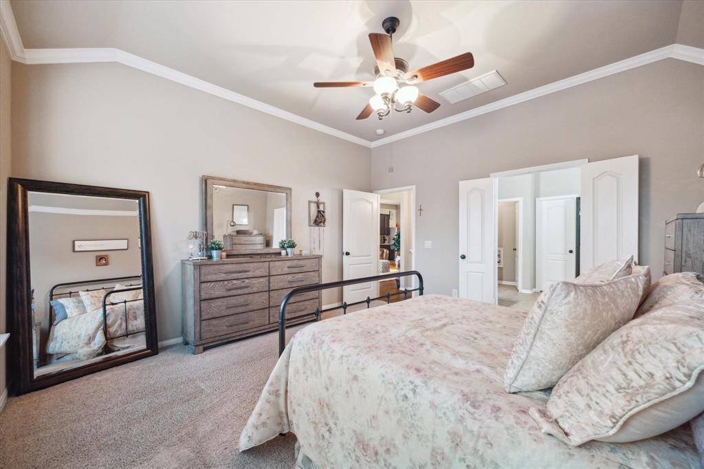 Rich carpet and warmly painted walls create a cozy feel in the primary.