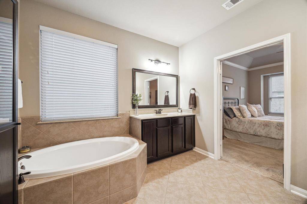 Melt away the day’s worries in the primary en suite large soaking tub.