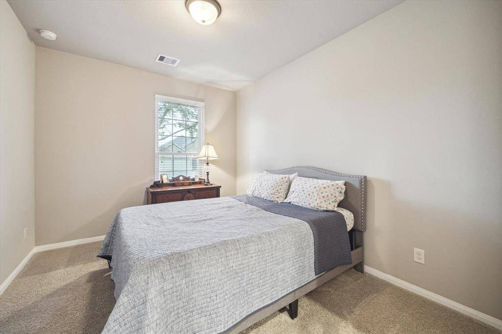 Secondary bedroom with a neutral palette invites peace and relaxation.