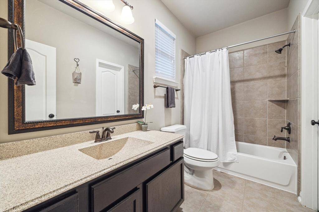 The en suite guest bathroom suite includes a tub and generous counter space.