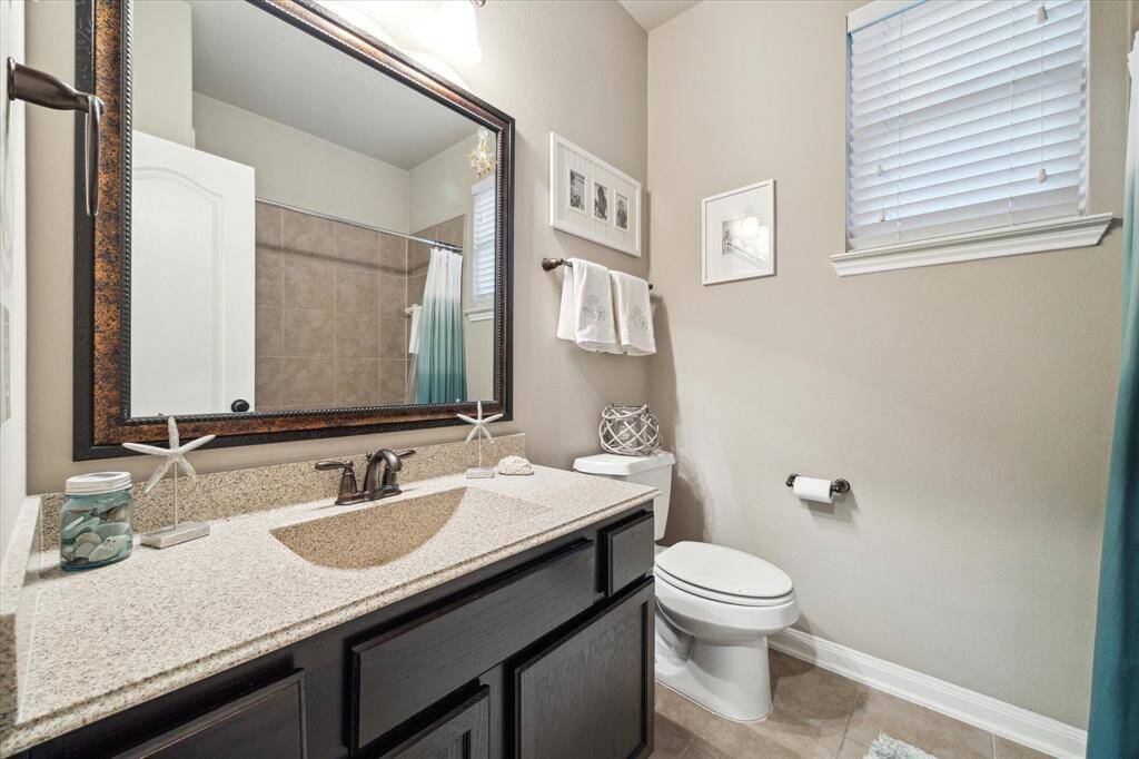 All bathrooms are well-appointed with handsome cabinetry and countertops.