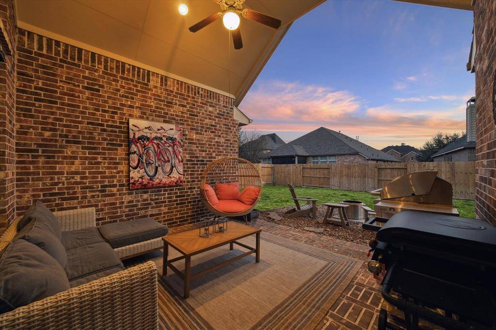 Unwind from the day taking in lovely skies sheltered from the Texas heat on the covered brick-wall patio.