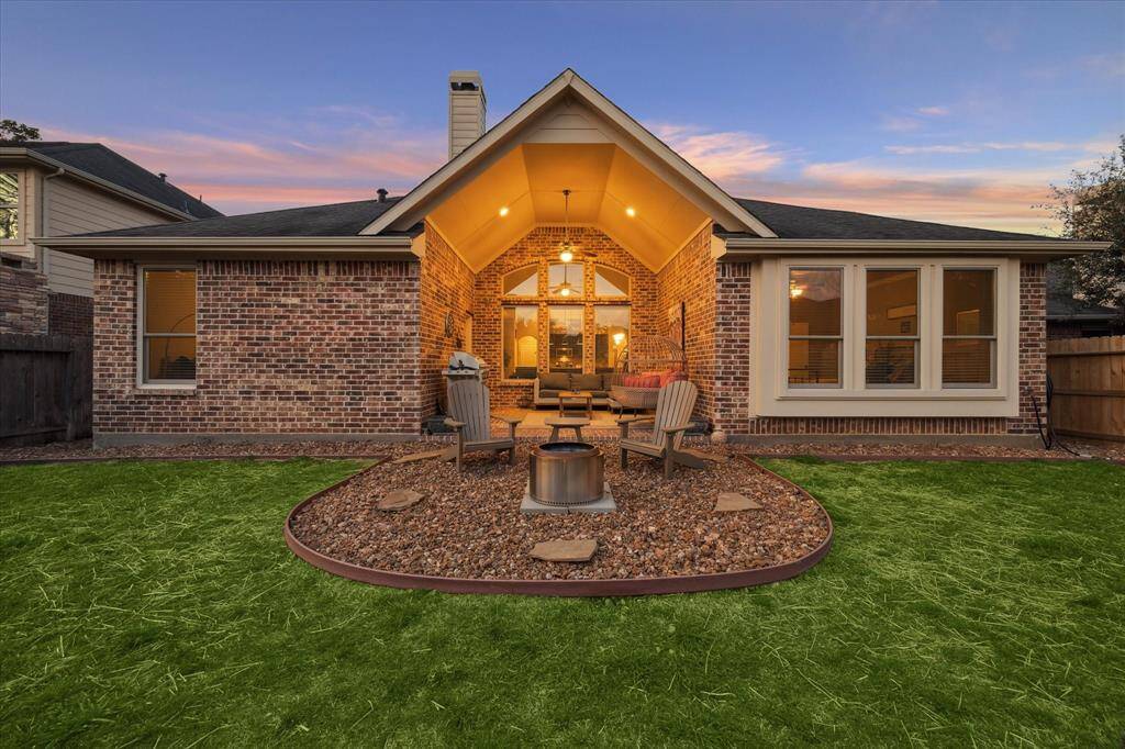 Barbecue Texas-style next to the fire pit in the this well-loved outdoor space.