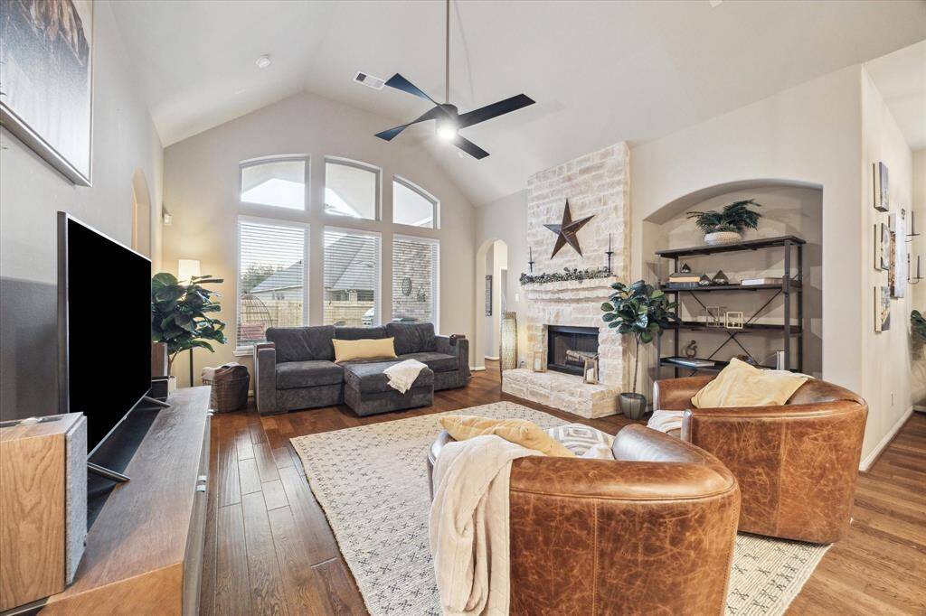 Natural light streams into the main living area through large abundant windows that reach to the vaulted ceiling.